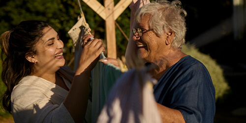 Elderly woman looking at her carer Elderly woman looking at her carer